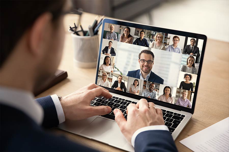 Anywhere Operations — Businessman using laptop for virtual team conference
